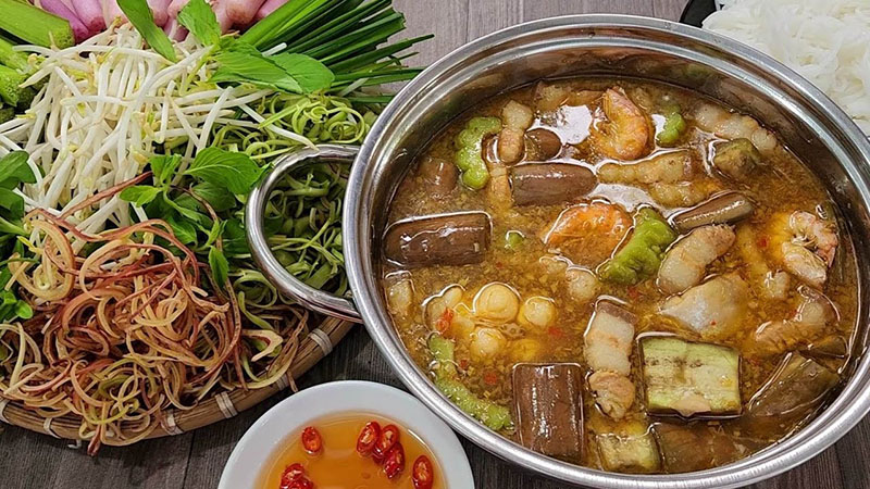 Lau Mam Mekong Delta hotpot served with vegetables and rice noodles